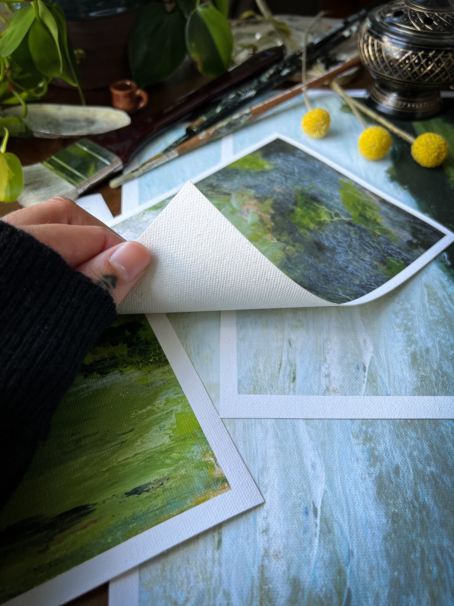 hand holding landscape archival giclée matte canvas print to show fibers underneath canvas