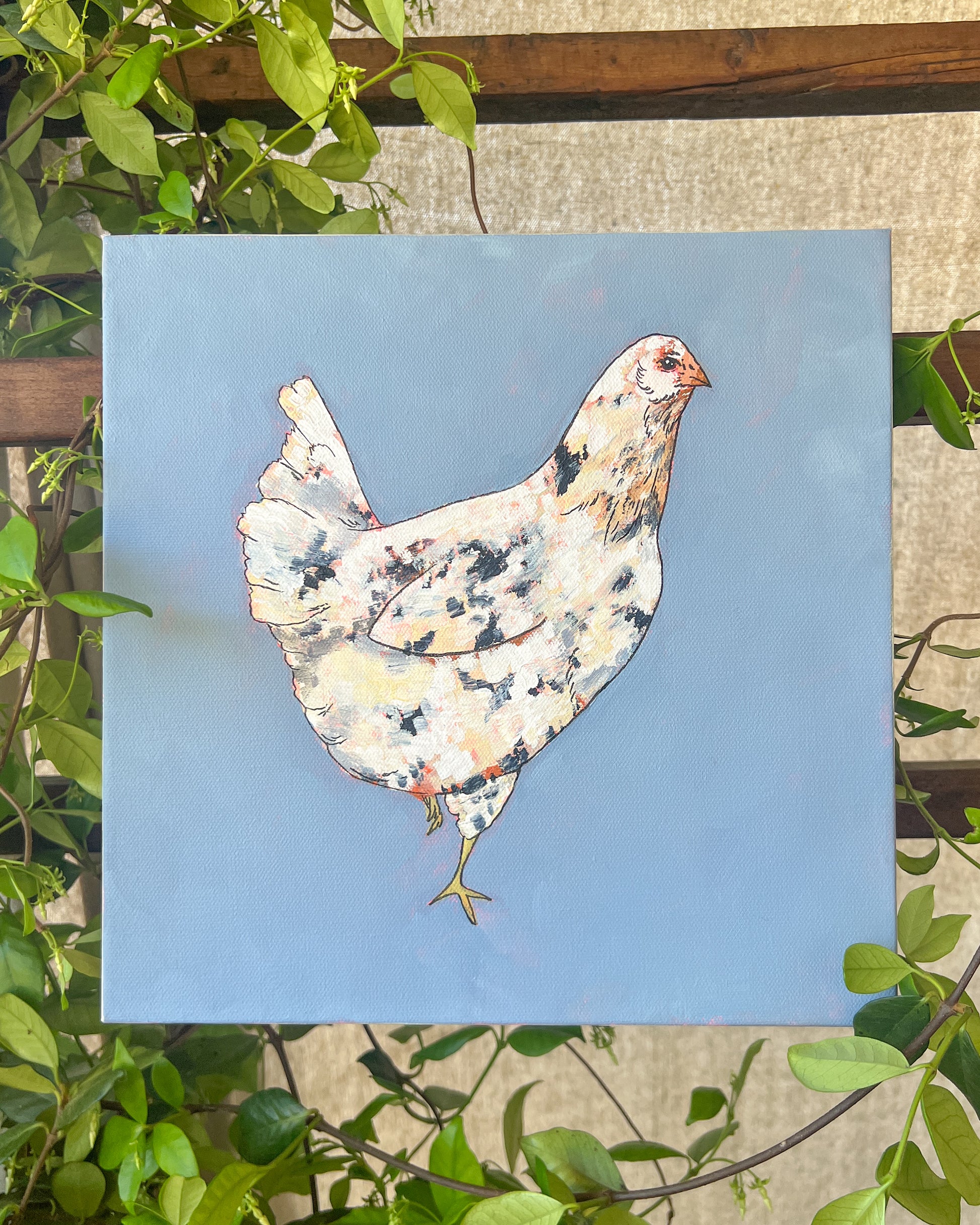 chicken painting with blue background and greenery surrounding