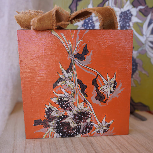 Original acrylic painting of dried sunflowers with an orange background and a brown velvet ribbon to hang