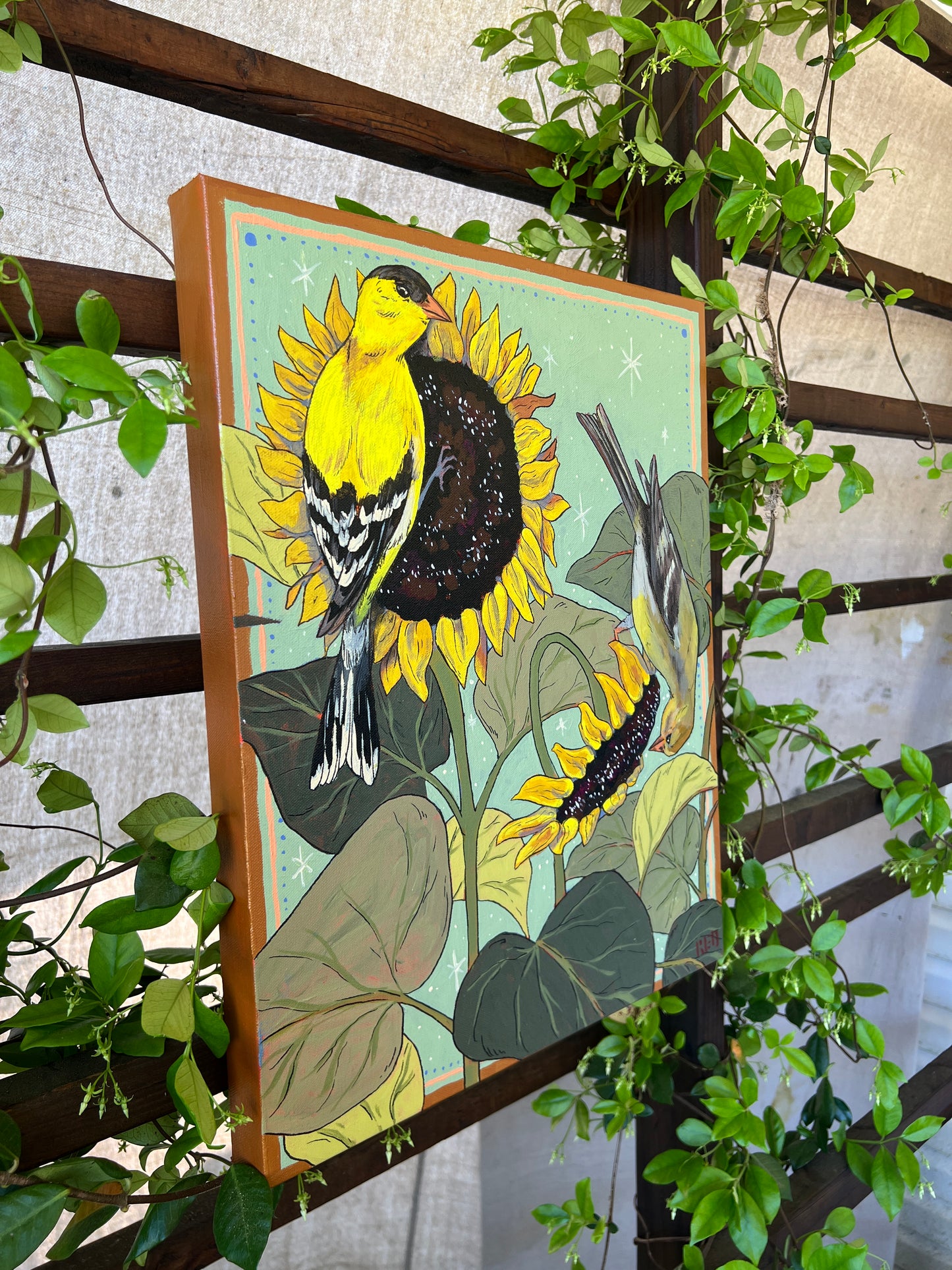 Original painting with two gold finches on sunflowers, surrounded by greenery