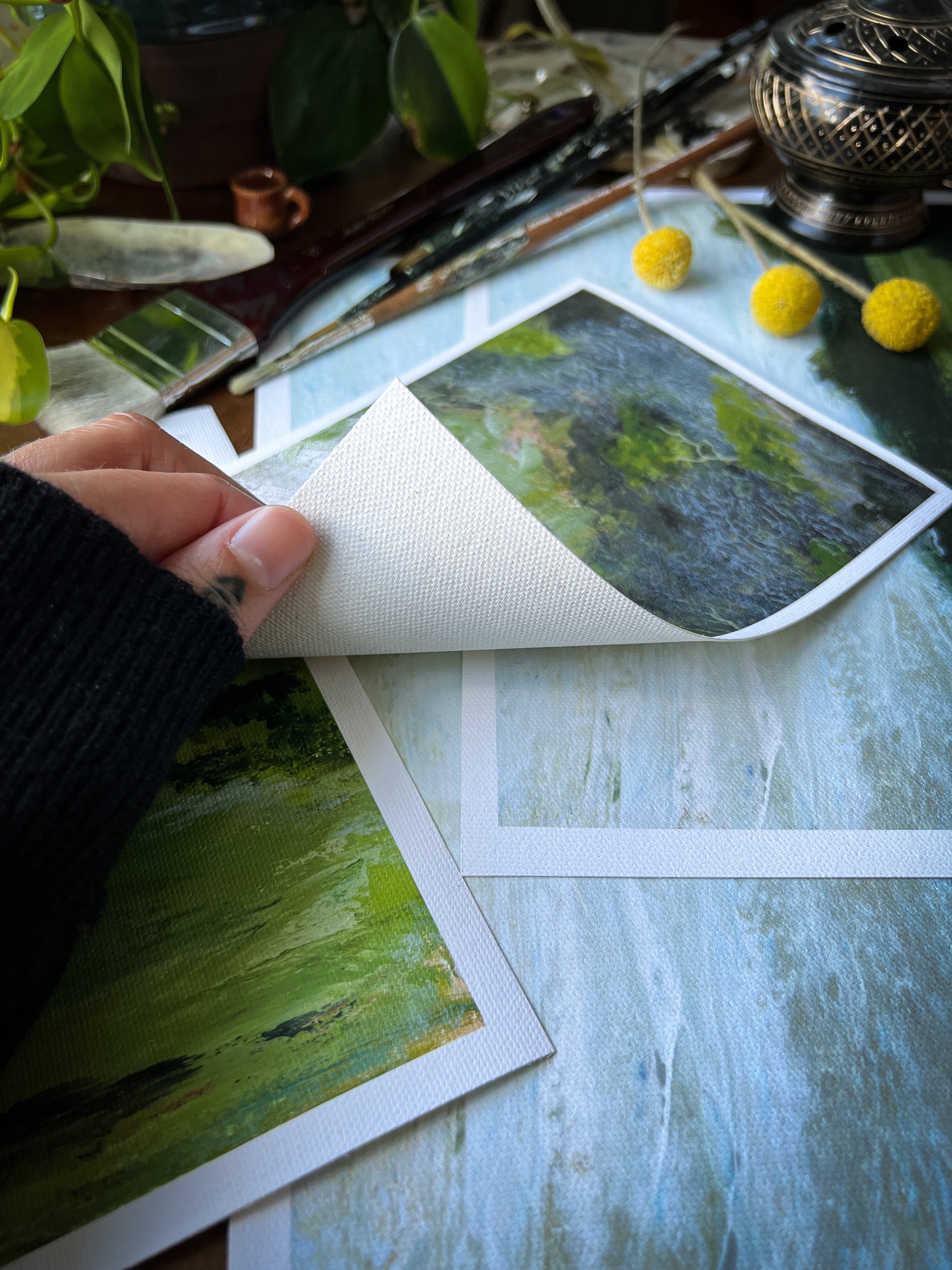 hand holding landscape archival giclée matte canvas print to show fibers underneath canvas